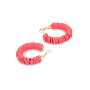 Detailed macro view of vibrant rose red polymer clay discs on gold circular hoop earrings