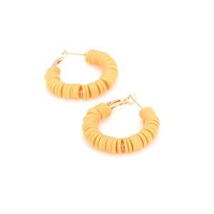 Detail of yellow Heishi clay bead hoop earrings with polished rose gold metal clasp