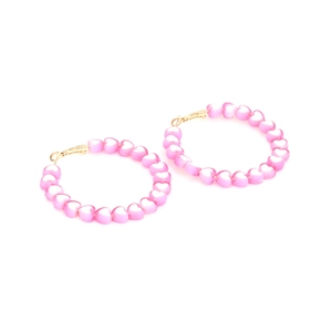 Pink heart beaded hoop earrings with gold metal hooks on white background