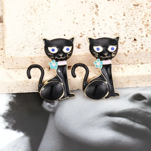 Boucles d'oreilles chat en émail noir avec yeux en strass bleus et détail floral