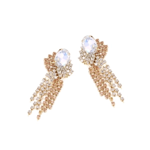 Detailed close-up of golden tassel earrings with sparkling rhinestones and crystal stones