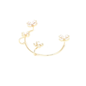 Elegant gold open bangle with four white pearl flower clusters on a clean white background