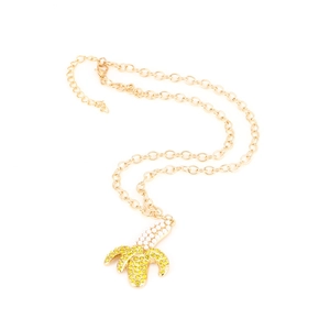 Golden banana pendant necklace featuring yellow rhinestones and white pearl details