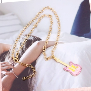 Chunky gold chain necklace featuring a pink and yellow enamel guitar pendant with crystals