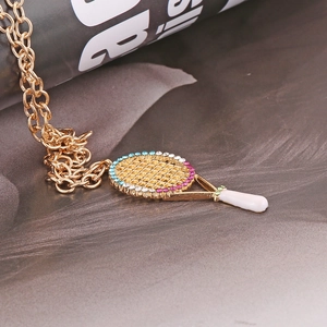 Golden necklace featuring a tennis racket pendant with colorful sparkling rhinestones