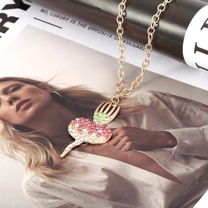 Charming heart pendant necklace with pink and white rhinestones on a gold chain