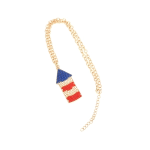 Detail view of a flag-inspired geometric pendant with red white and blue beads on a gold chain
