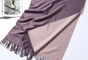 Detail of two-tone purple and pink pashmina scarf showing soft texture and tassels