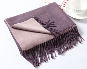 Close-up of double-sided purple and pink cashmere scarf with soft tassel edges