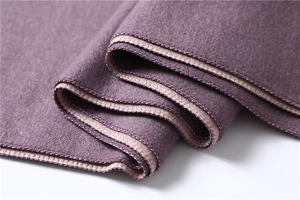 Detailed close-up of dark purple cashmere scarf featuring soft texture and contrast stitching