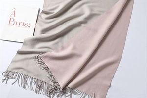 Detail of pink and gray cashmere scarf with tassel edges and French style magazine
