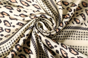 Macro view of leopard print silk-like satin fabric with detailed geometric patterns