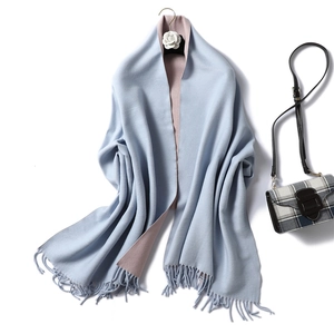 Close-up of double-sided cashmere-like scarf with fringe edges in blue and pink