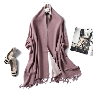 Close-up of soft cashmere-feel scarf with elegant tassels and stylish accessories