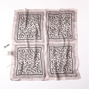 Flat lay of leopard print silk scarf in light pink with professional square design