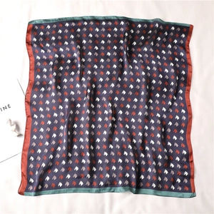 Close-up of square silk scarf with vintage horse head print and contrasting border