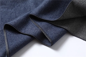 Detailed close-up of navy blue and grey cashmere-like scarf with reinforced edge stitching