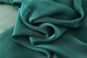 Dettaglio macro del tessuto leggero verde scuro con texture e lucentezza