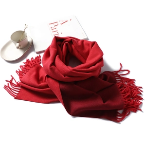 Close-up of red and wine double-sided cashmere-like scarf with elegant tassel edge