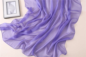 Dettaglio ravvicinato dello scialle in chiffon viola con trama morbida e orlo rifinito