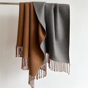 Solid cashmere-feel scarf in camel and grey with double-sided design and tassels