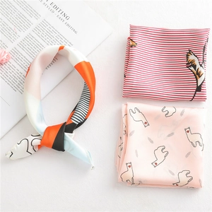 Three elegant silk scarves with leopard, geometric, and crane prints on white background