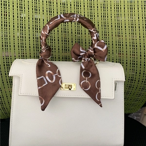 White lychee leather handbag with silk scarf wrapped handle and gold twist lock