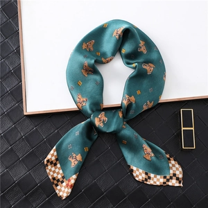 Emerald silk scarf featuring cute bear print and vintage checkered border in flat lay view