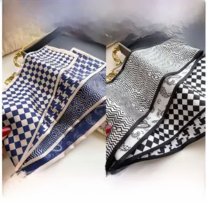 Detail of silk scarves featuring classic checkered, wavy, and paisley printed patterns