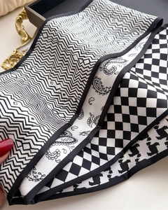 Close-up of a double-layered skinny scarf with geometric patterns and silky texture