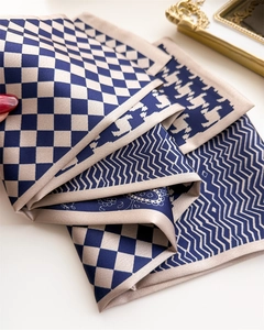 Close-up of geometric pattern silk scarf with plaid, houndstooth, and paisley prints