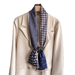 Geometric checkered skinny silk scarf in navy and beige paired with a beige blazer