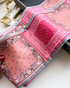 Détail d'un foulard en soie avec motifs cachemire paisley et textures rose vif