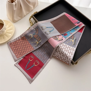 Equestrian print silk twilly scarf with horse and stirrup patterns in a chic tray setting