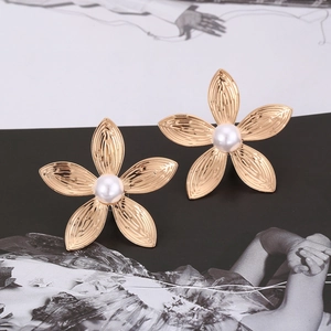 Vintage gold flower earrings with pearls on fashion magazine, bohemian style jewelry
