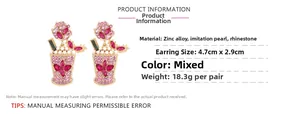 Detail view of crystal-encrusted drink cup earrings with pearl accents and dimensions