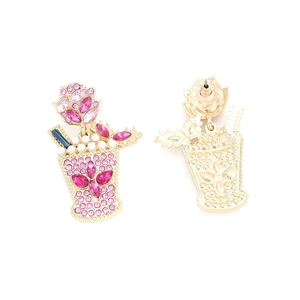 Detail of pink crystal wine glass earrings with pearls and gold straw accents