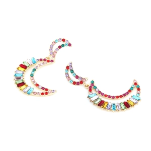Close-up of golden crescent moon earrings with vibrant multi-colored inlaid rhinestones