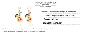 Detail of cute cocktail glass earrings with colorful rhinestones and imitation pearls
