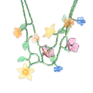 Detail of colorful beaded flower necklace with green vines and handmade floral petals