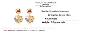Detail of gold heart earrings featuring multi-colored rhinestones and zinc alloy finish