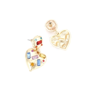Detail view of heart-shaped earrings featuring colorful gemstones and gold-tone plating
