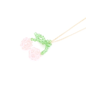 Handmade crystal cherry pendant necklace with a gold chain on a clean white background