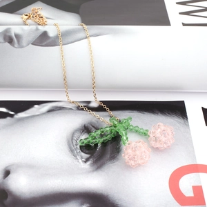 Handmade crystal cherry pendant necklace with pink glass beads on a gold-plated chain