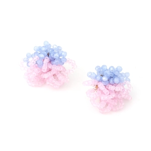 Macro detail of handmade beaded flower earrings featuring pink and blue crystal beads