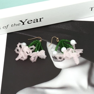 Handmade beaded flower earrings with pink petals and green leaf details for women