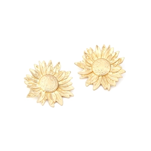 Vintage oversized gold sunflower earrings with textured metallic petals on white backdrop