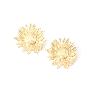 Close-up of golden sunflower earrings featuring textured petals and detailed metal centers