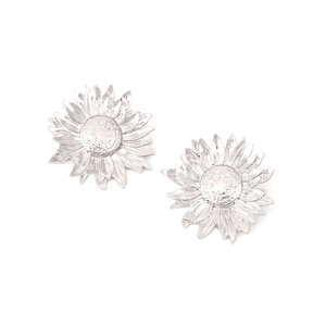 Macro detail of sunflower earrings with textured petals and granulated silver finish