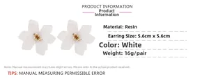 Detail view of large white resin flower earrings with size measurements and weights